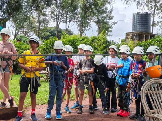 Pupils in helmets and harnesses getting ready for an activity